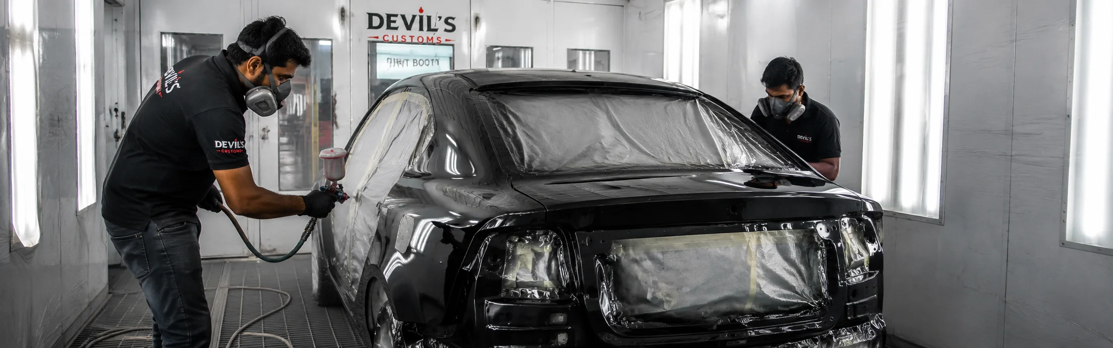 echnicians working inside the advanced paint booth for car denting painting at Devil’s Customs Sector 1 Noida